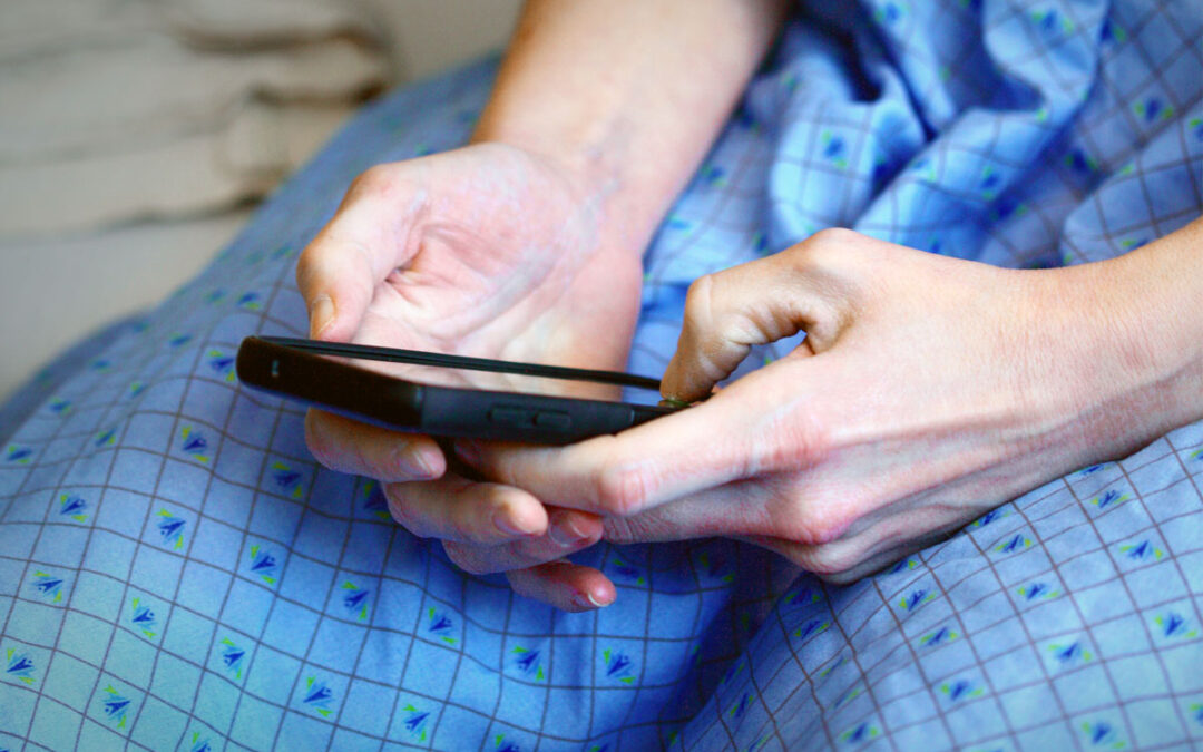 Patient holding mobile phone and seeking expert opinion